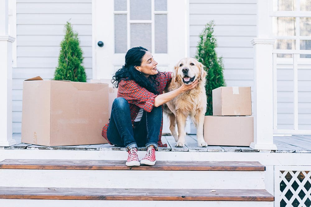Woman and her dog moving in to their new home