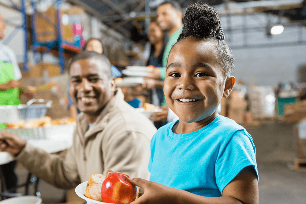 Child getting a meal from a hunger relief organization