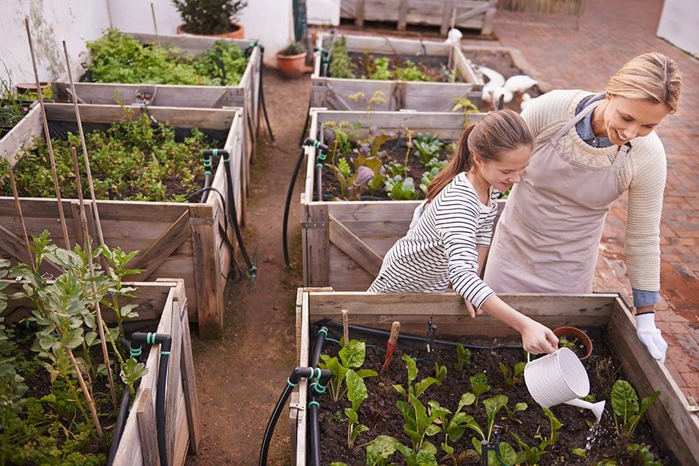 Mother and daughter container gardening together