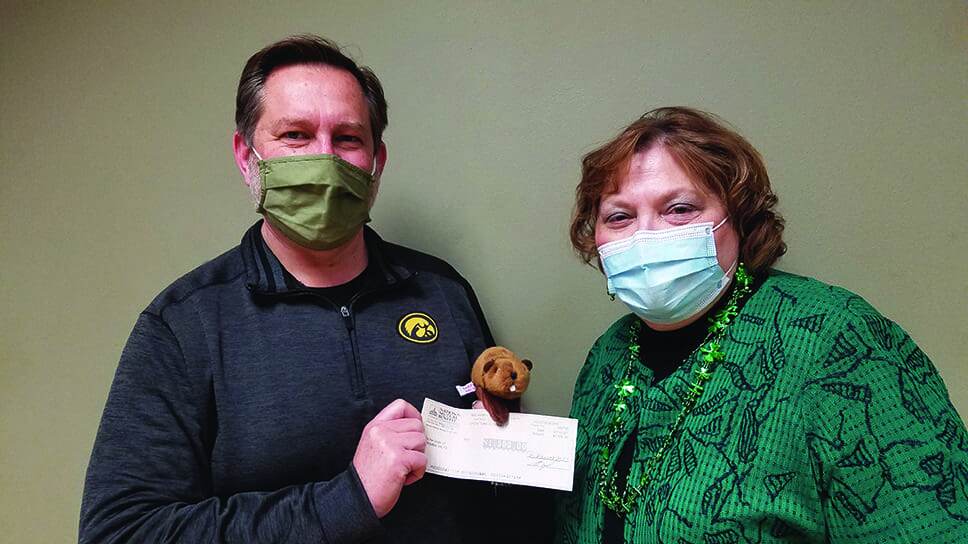 President Craig handing over a Disaster Relief Benefit Check