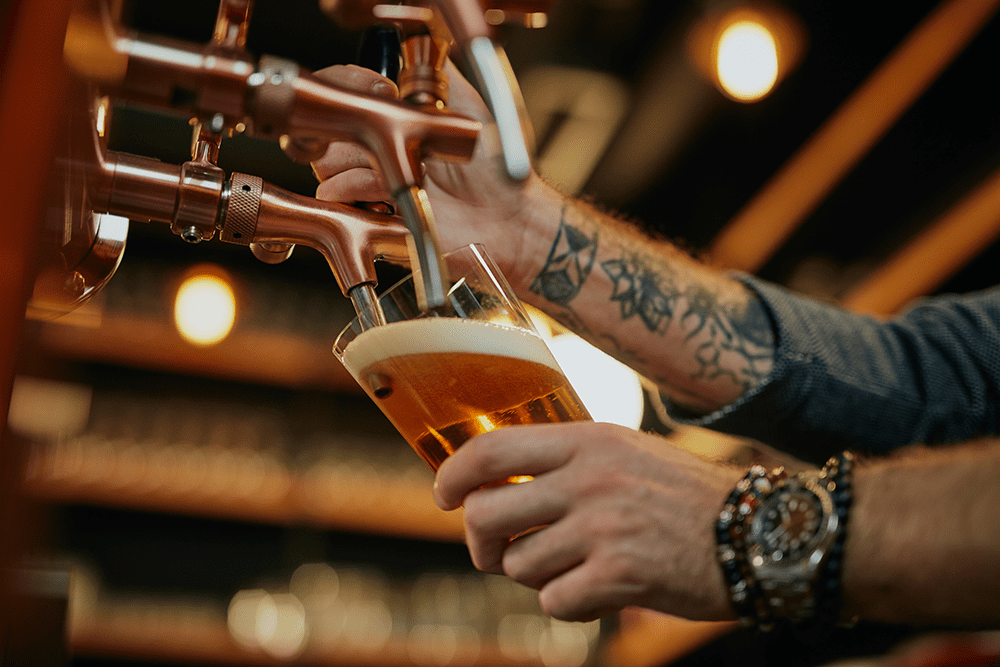 Bartender pouring beer at brewery