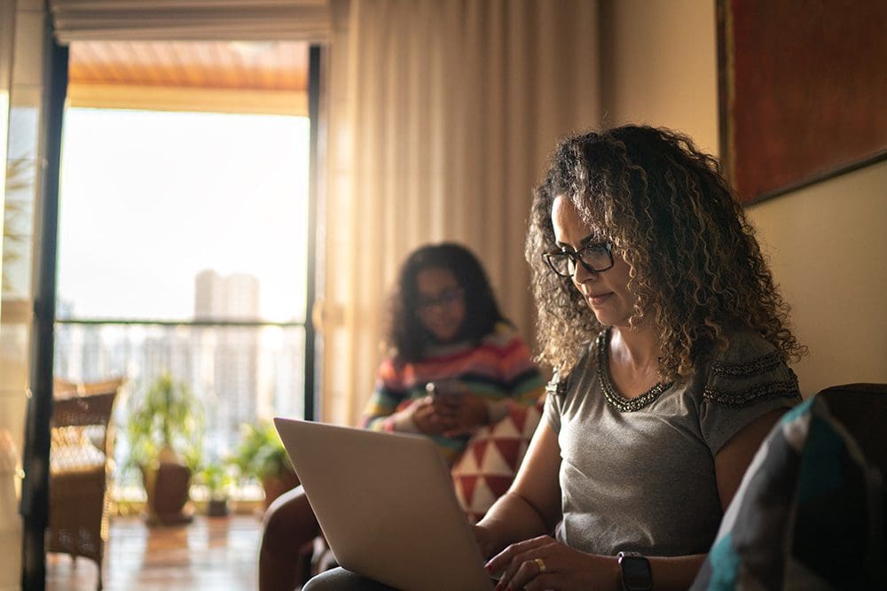 Woman on laptop looking up life insurance options