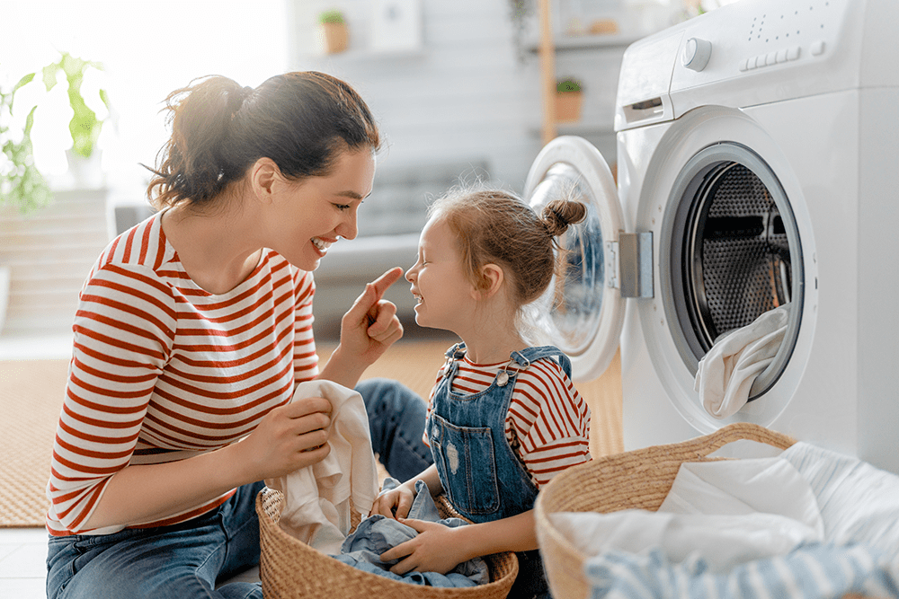 Mother and daughter doing laundry with natural products