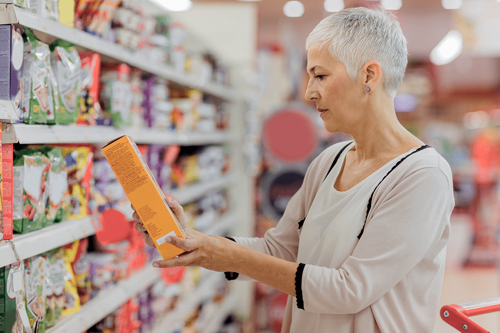 Woman reading cleaning product label