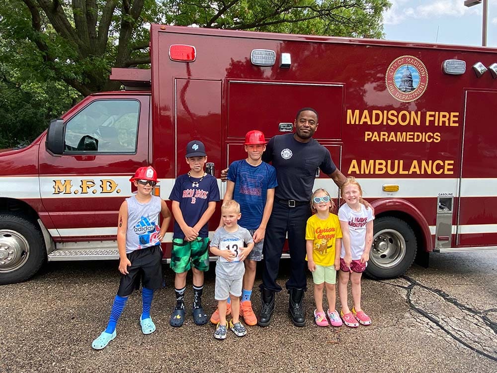Branch 200 kiddos posing with ambulance at BetterLife's Walk to End Hunger