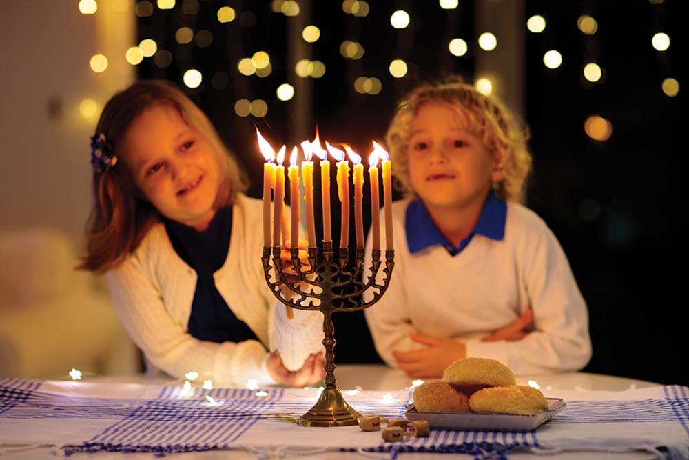 Children lighting the menorah for Hanukkah