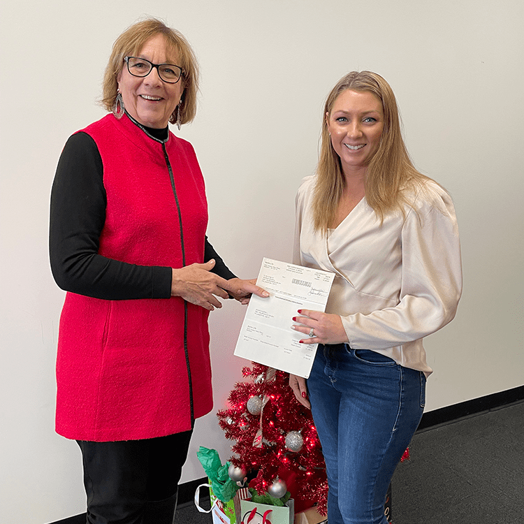 Diane Rook-Johnson presenting BetterLife Family Benefit check to Jessica Bodell