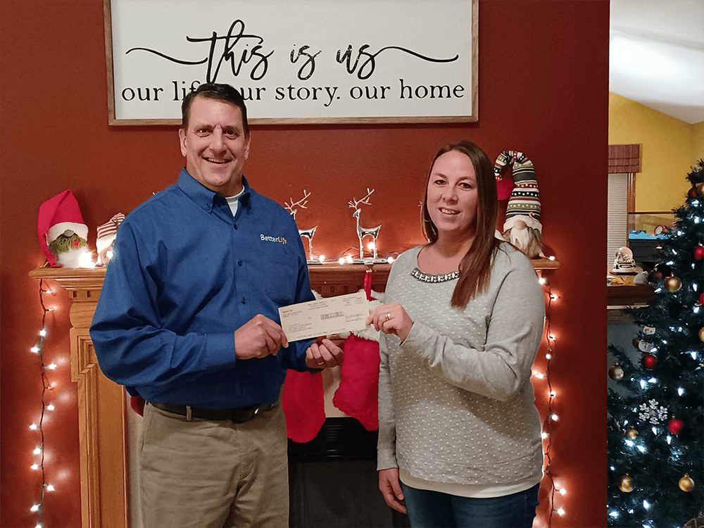 Agent Chris Deedon presenting BetterLife Family Benefit award to recipient Patricia Meyer