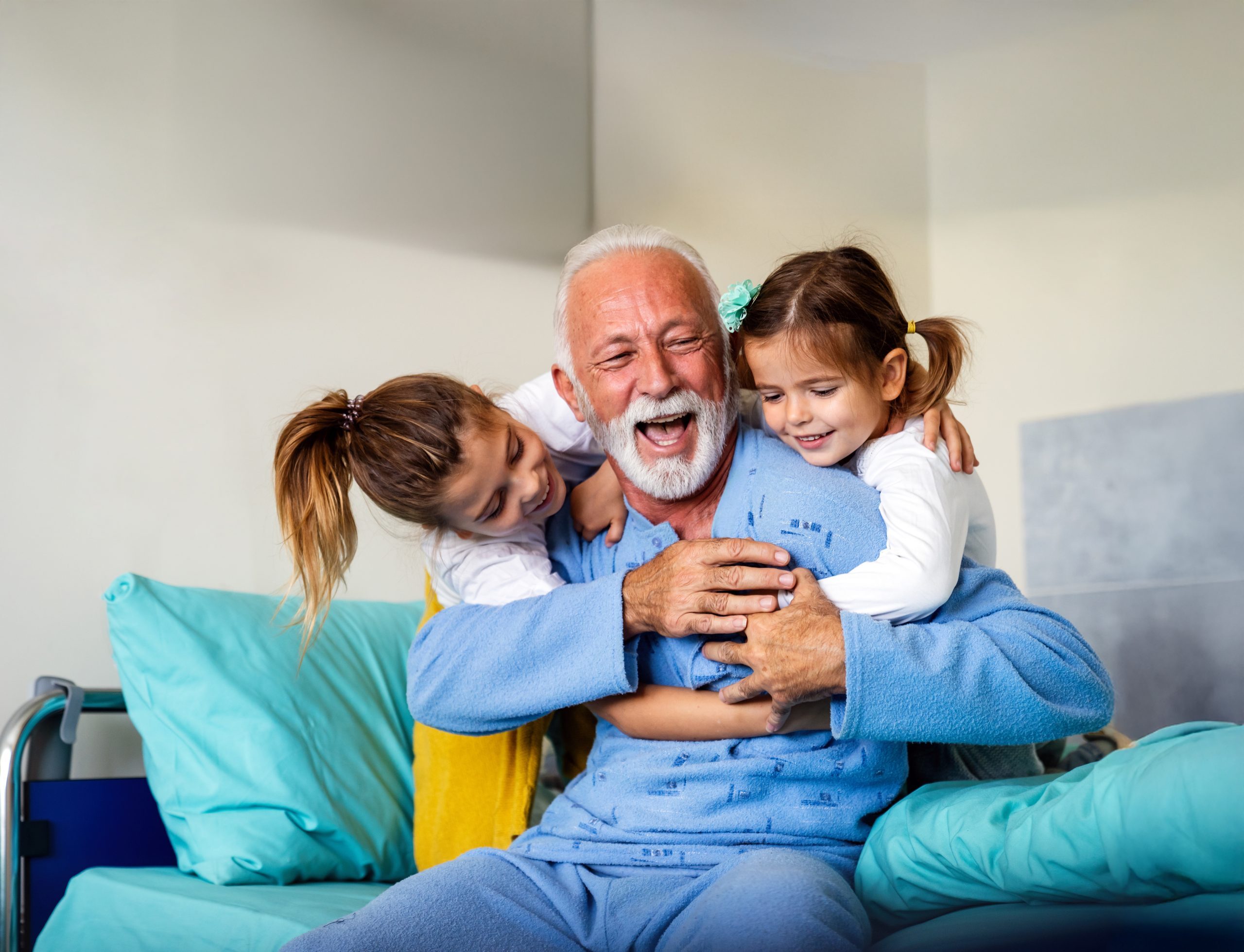 Happy grandfather and his grandchildren laughing and enjoying leisure time together. Family, support, fun concept