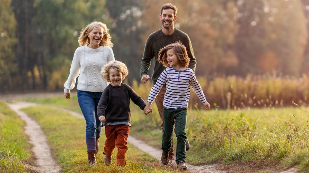Family running in a field