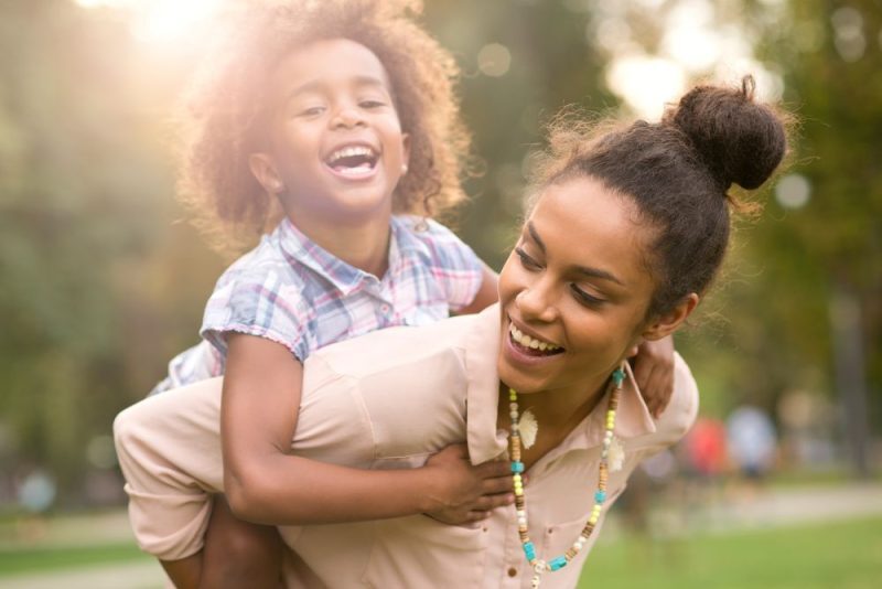 mother and daughter smiling at each other.