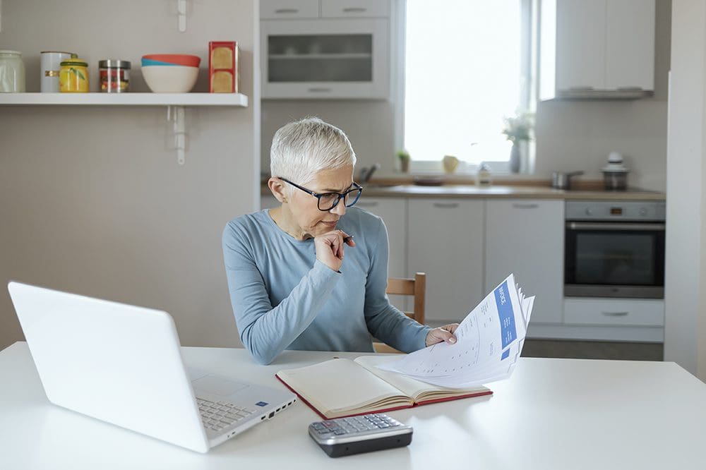 Woman calculating cost of life insurance