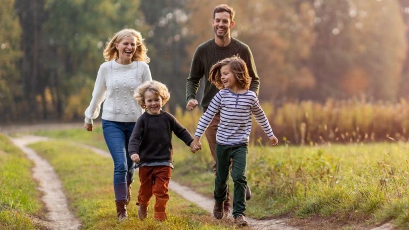 Family running in a field
